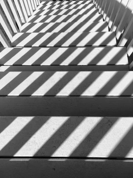 istock White stairs and railings with symetrical shadowed stairs 1135896159