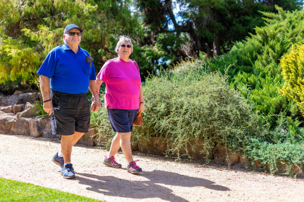 istock Active Senior Couple Walking in a Park Holding Hands 1135896314