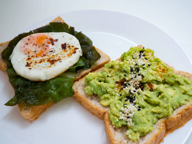 istock Appetizing bruschetta with egg and avocado on a plate. 1135898566