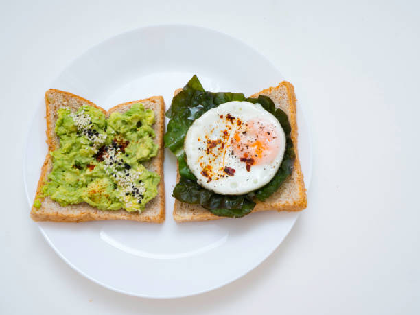 istock Appetizing bruschetta with egg and avocado on a plate. 1135898574