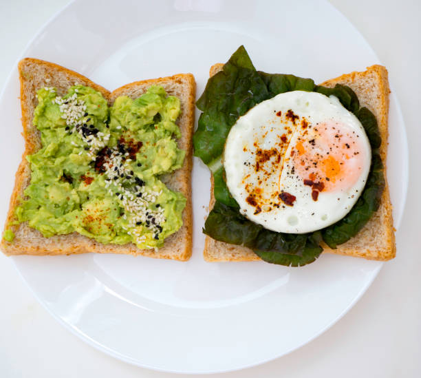 istock Appetizing bruschetta with egg and avocado on a plate. 1135898576