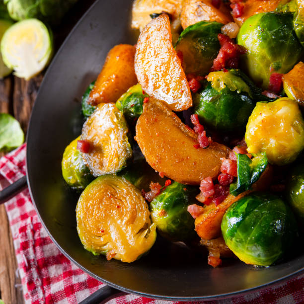 Brussels sprouts potato pan with bacon in rustic style