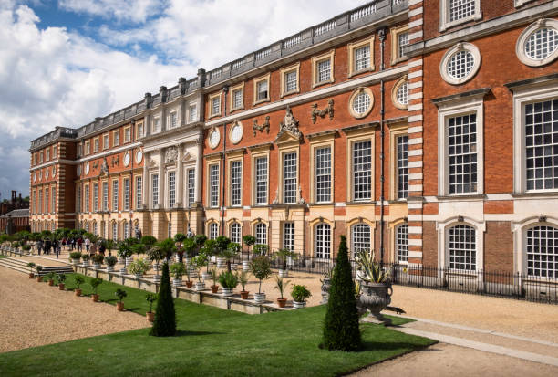 Facade and gardens at Hampton Court Palace. stock photo