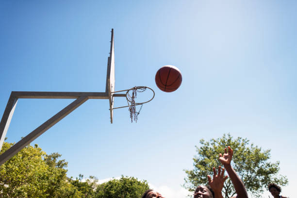 istock Female athletes playing basketball on sunny day 1135899954