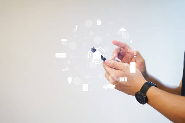 istock close up man hand holding smartphone for using home automation and turn on monitor function to looking inside or outside home and property , ai innovation future concept 1135899956