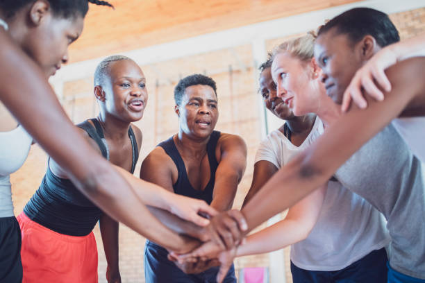 istock Female basketball team stacking hands on court 1135900005
