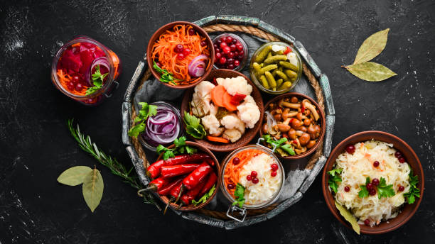 istock Stuffed vegetables and mushrooms on the kitchen table. Cabbage, mushrooms, cucumbers, cauliflower. Top view. Free space for your text. 1135900838