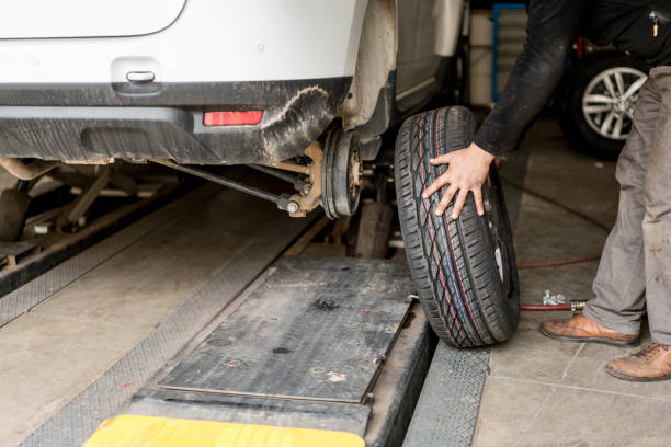 istock Car mechanic changing tires 1135901160