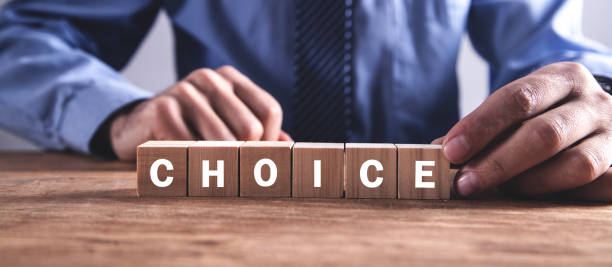 istock Man holding wooden cube with Choice word. 1135904831