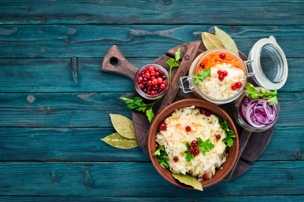 istock Sauerkraut in a jar on a kitchen table. Cabbage, cauliflower. Top view. Free space for your text. 1135908580