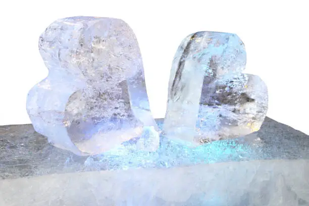 Two ice sculptures in the shape of a heart and the blue backlight