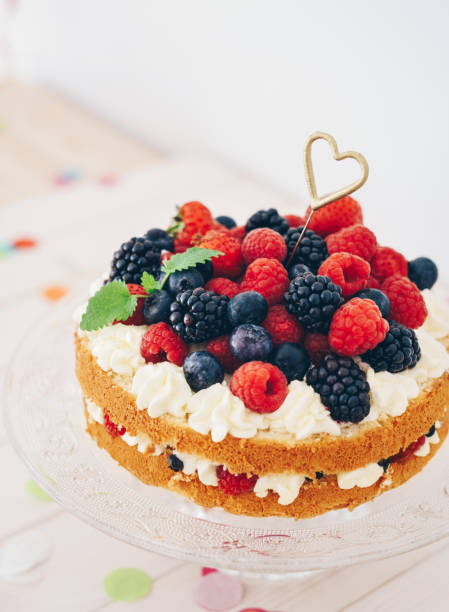 Berry cake with heart shaped sparkler and confetti