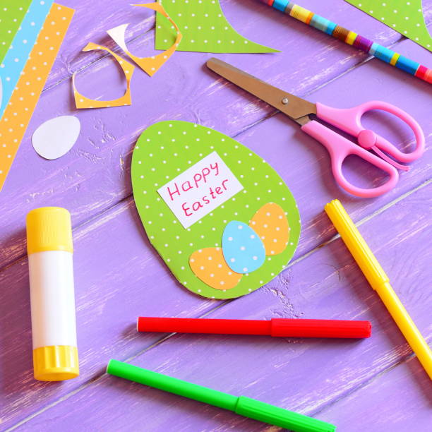 istock Happy Easter card in egg shape. Materials and tools to create Easter paper greeting card. Easy and fun Easter paper crafts for kids 1135912646