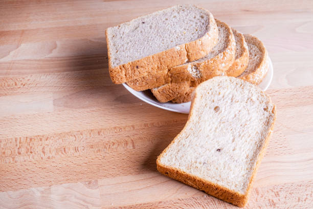 istock Slice whole wheat bread on wooden floor background. 1135915425