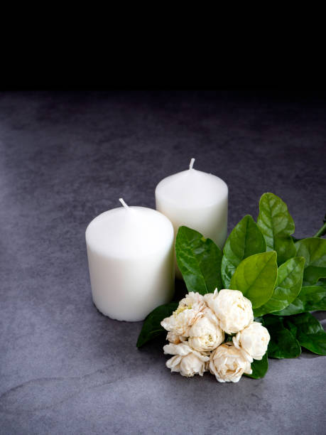 istock Jasmine flowers and candles on a black background 1135915638