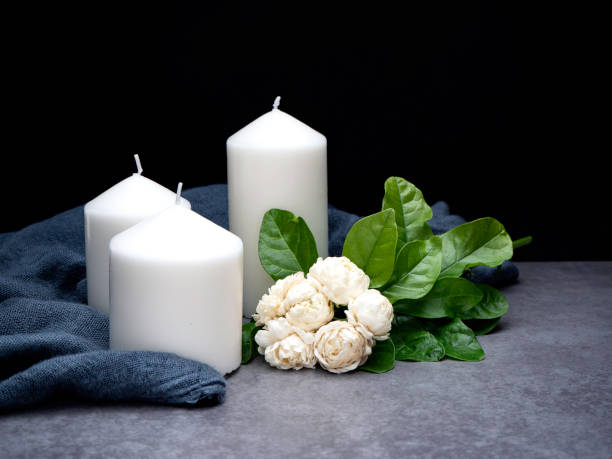 istock Jasmine flowers and candles on a black background 1135915644