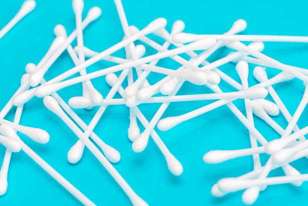 istock White cotton buds scattered on blue background 1135918343