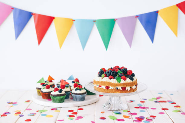istock Berry cake and chocolate cupcakes with colourful confetti and bunting 1135919318