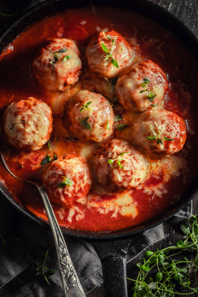 istock Tasty meatballs with fresh herbs and tomatoes 1135920324