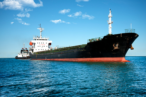 Ship and tugboat in the harbor