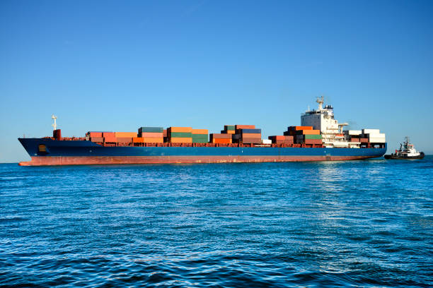 istock Ship and tugboat in the harbor 1135920910