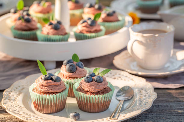 istock Sweet brown cupcake in sunny summer garden 1135921111