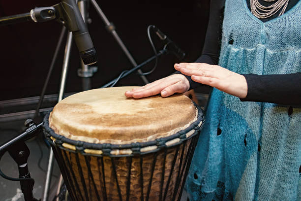 istock African drum, microphone studio recording, drummer beats the drum with his hands movement 1135921242