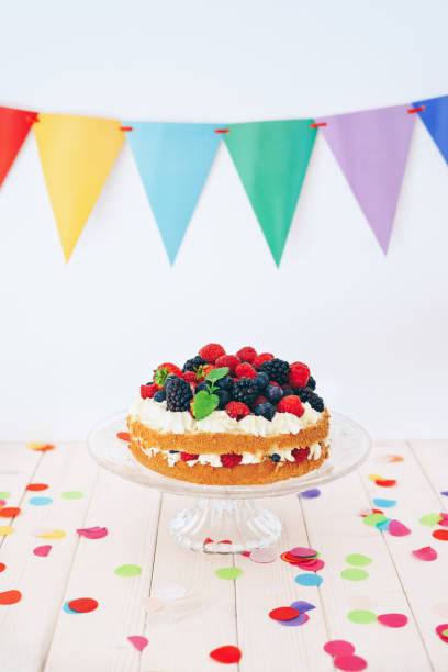 istock Berry cake with colourful confetti and bunting 1135923541