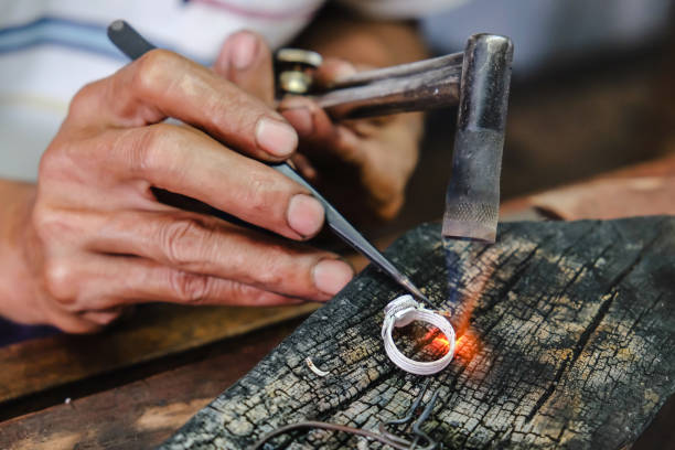 silversmith making jewelry - thirty pieces of silver imagens e fotografias de stock