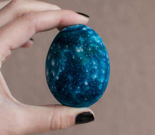 istock Girl holding a beautiful Galaxy Easter egg 1135926139