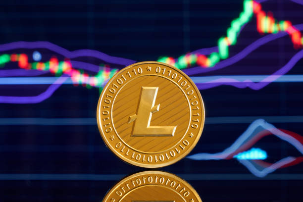 Gold coin litecoin on a bright background of business graphics close-up. Crypto-currency. Anonymous. Virtual currency Gold coin litecoin on a bright background of business graphics close-up. Crypto-currency. Anonymous. Virtual currency litecoin stock pictures, royalty-free photos & images