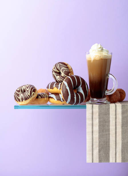istock Chocolate donuts and coffee cocktail with cream. 1135929616