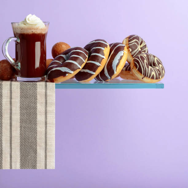 istock Chocolate donuts and hot chocolate with cream. 1135929620