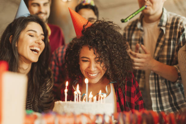 Happy birthday dear friend concept Excited girl ready to blow out candles on cake on birthday party with happy friends. Happy birthday dear friend concept woman birthday cake stock pictures, royalty-free photos & images