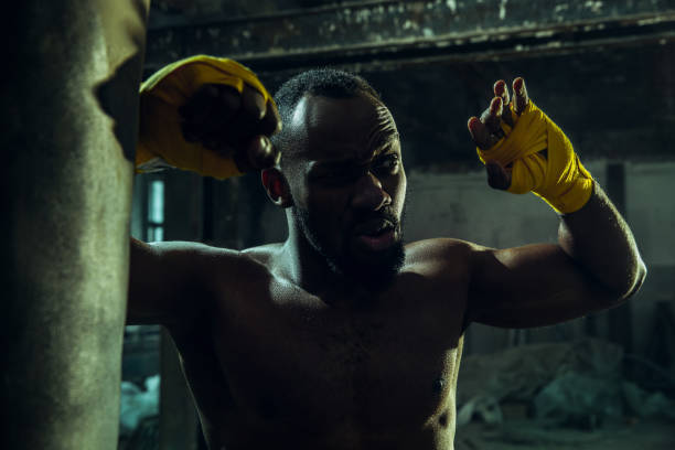 istock Hand of boxer over black background. Strength, attack and motion concept 1135930839