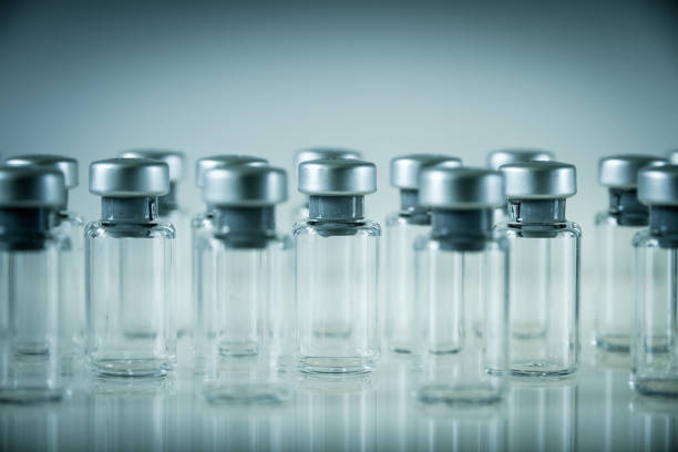 istock Vaccine glass bottles on grey background 1135930861
