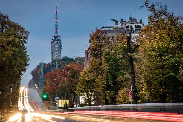 Cityscape during twilight and the TV/radio tower in downtown Sofia city, Bulgaria, Eastern Europe. Long exposure with blurred lights from the road traffic. Shot on Canon full frame EOS R full frame system.