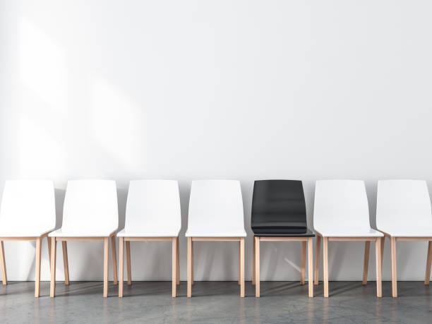 istock Blank wall Mockup with row of chairs in empty room, not like everyone else 1135933778