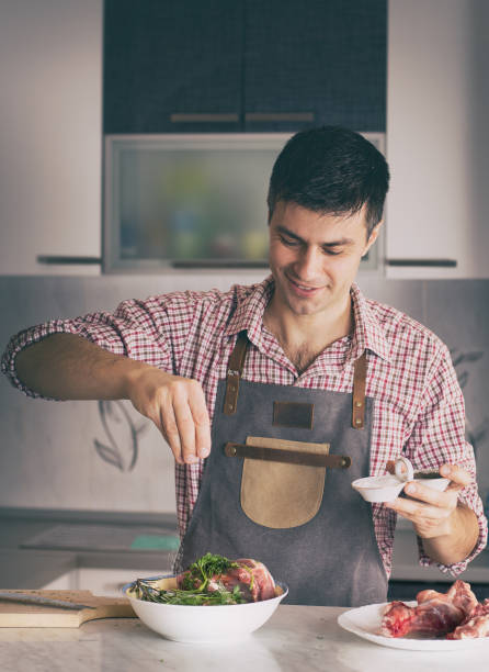 istock Man cooking at home 1135933857
