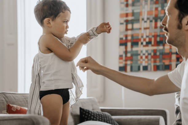 Father helping son dressing up