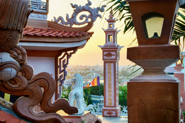 view of the city of phan thiet through the sculptural compositions of buddhist temple, vietnam. - gold pagoda temple synagogue imagens e fotografias de stock