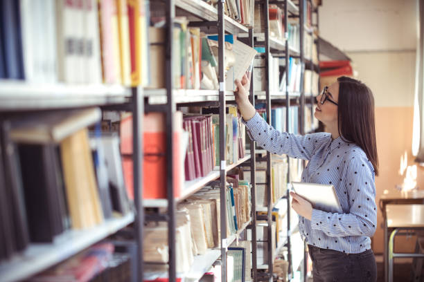 istock Portrait of a gorgeous student using a tablet computer in a library 1135935562