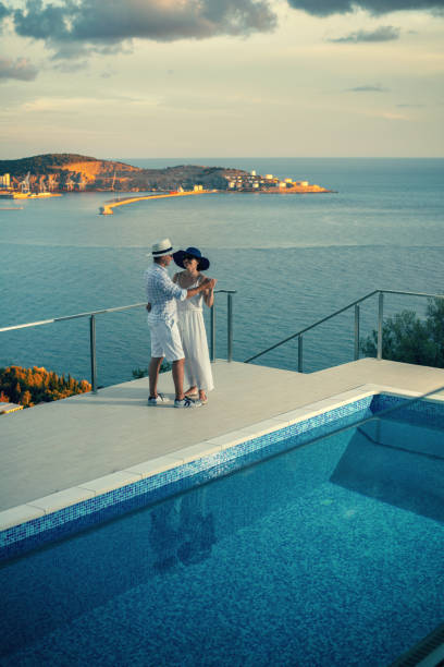 istock Happy couple dancing by the poolside 1135935857