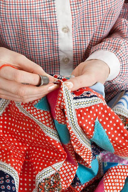 istock Close-up of woman's hand stitching quilting 113593630