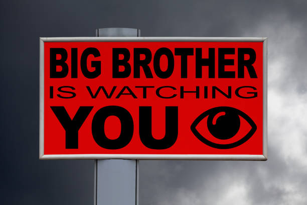 Billboard - Big Brother is watching you Close-up on a red billboard against a cloudy sky with the message "Big Brother is watching you" written in the middle next to an eye icon. dictator photos stock pictures, royalty-free photos & images