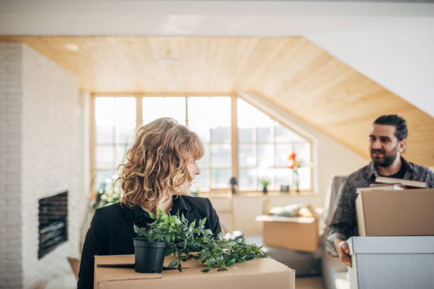 istock Couple carrying boxes in new apartment 1135938496