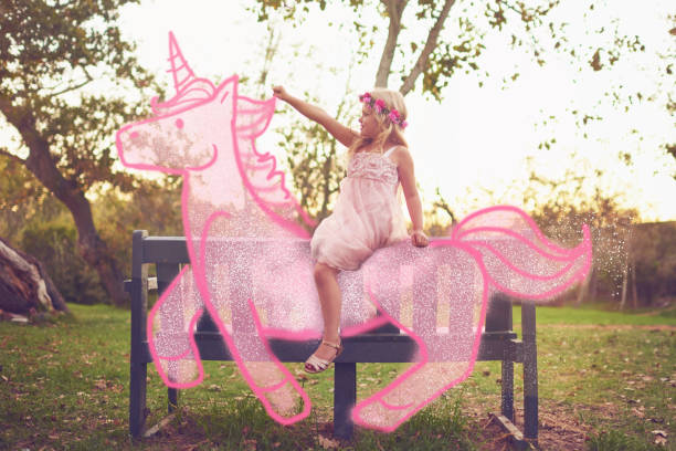 Every princess rides away into the sunset on a unicorn Shot an adorable little girl riding a pink toy unicorn outdoors Unicorn stock pictures, royalty-free photos & images