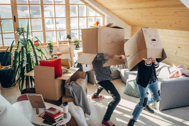 istock Couple having fun with cardboard boxes in new apartment 1135940967