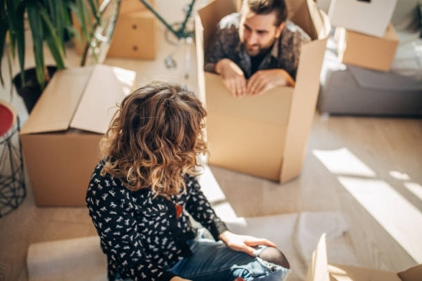 istock Couple having fun unpacking in new home 1135941287