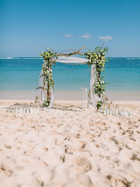 istock Wedding arch with white flowers at blue ocean in island 1135941732